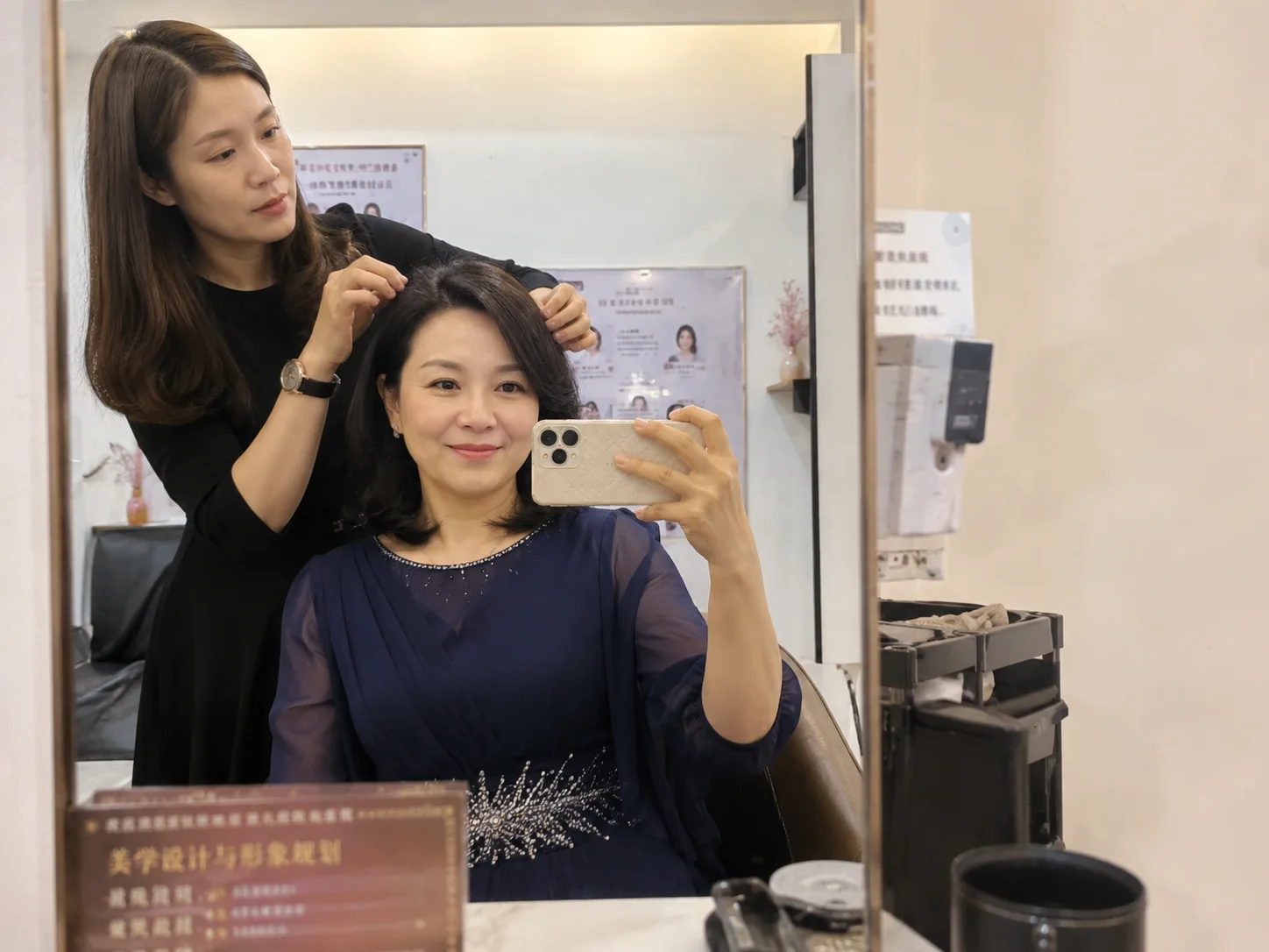 M&MY special occasion wig styling solution with consultant adjusting the hairstyle in salon mirror